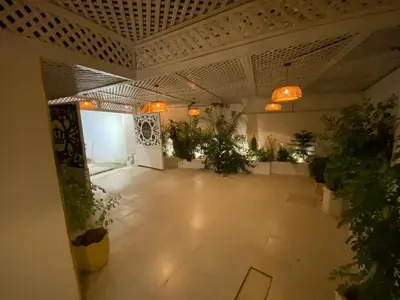an empty room with potted plants in a building at Sanad Apartment شقة فندقية in Aqaba
