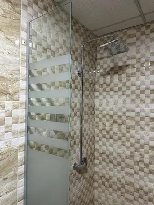 a shower with a glass door in a bathroom at Eden Hotel in Aqaba