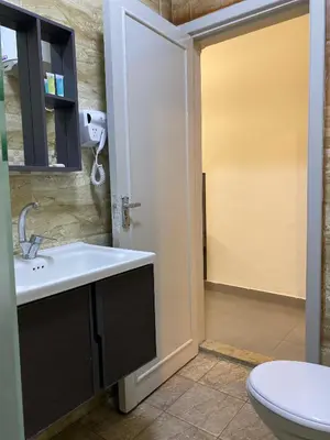 a bathroom with a sink and a toilet at Eden Hotel in Aqaba