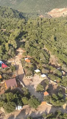 an aerial view of a village with houses and trees at Maple forest park cabins in Sākib
