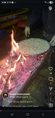 a pizza sitting on top of a fire at Maple forest park cabins in Sākib
