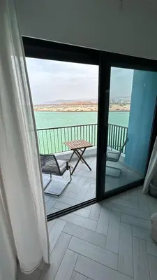 a view of a balcony with a table and chairs at Ayla Aqaba Azure 2 bedroom in Aqaba