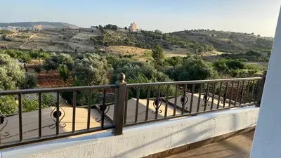 a balcony with a view of a hill and trees at شاليه جبال سوف in Jerash