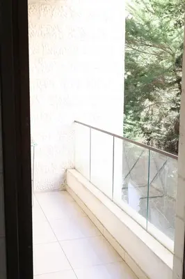 a balcony with a view of a white brick wall at Rams Der Ghbar 3BR cozy Apt in Amman