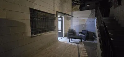 an empty hallway with two chairs in a building at الريان in Amman
