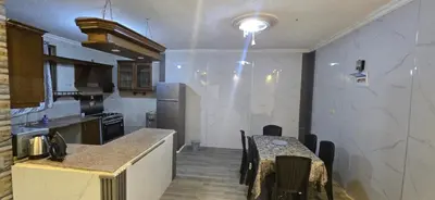 a kitchen with a table and a counter top at الريان in Amman