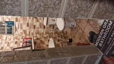 a bathroom with a toilet paper dispenser on a wall at بيت جدي in Dana
