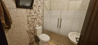 a bathroom with a toilet and a sink at شقة مفروشة في طبربور 3 غرف نوم in Amman