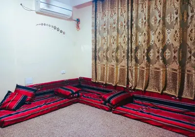 a group of red pillows sitting next to a curtain at Petra Triclinium Home in Wadi Musa