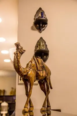 a statuette of a camel and two helmets at Antika Amman Hotel in Amman
