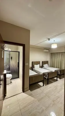 a hospital room with two beds and a bathroom at Antika Amman Hotel in Amman