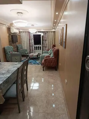 a living room with a table and chairs at رميمين هاوس