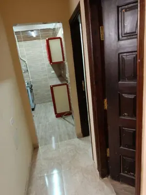 a hallway of a bathroom with a mirror at رميمين هاوس