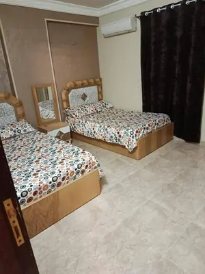 two beds sitting in a room with at رميمين هاوس