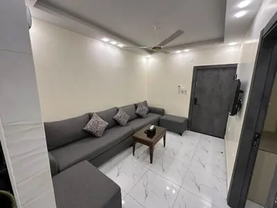 a living room with a couch and a television at Old Town Hotel in Aqaba