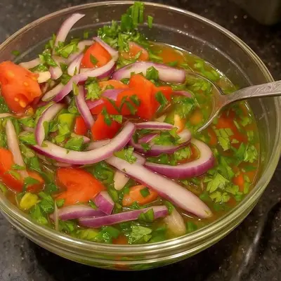 a bowl of vegetable soup with a spoon in it at سونا موتل in Sūf