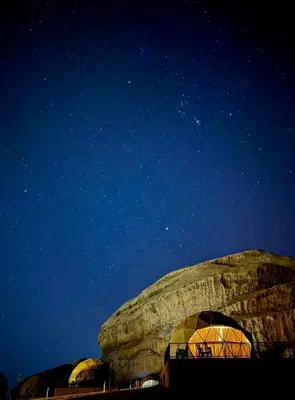 a group of domed buildings under a night sky at Wadi Rum Sand Camp in Al Jafr