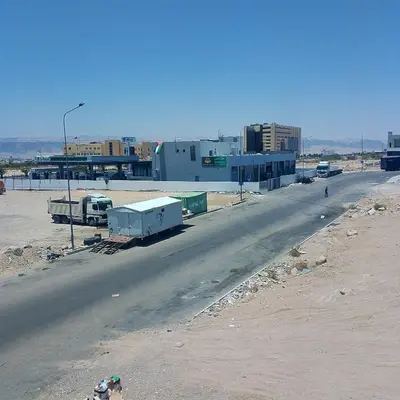 an empty road in front of a large building at New Room in Aqaba
