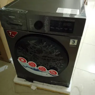 a microwave oven with stickers on the front of it at New Room in Aqaba