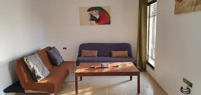 a living room with a couch and a coffee table at swahmaya apartments for rent in Sowayma