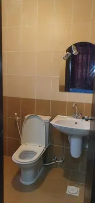 a bathroom with a toilet and a sink at swahmaya apartments for rent in Sowayma