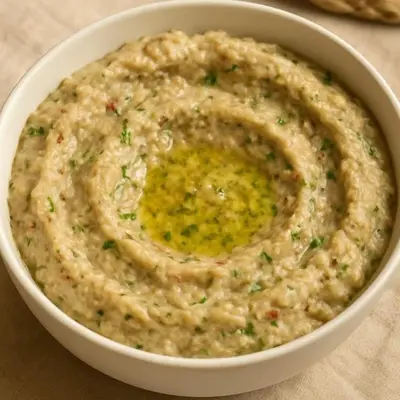 a bowl of hummus sitting on a table at فلورس لوج