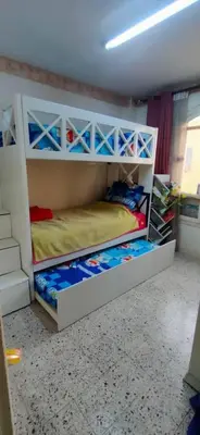 a bedroom with two bunk beds in a room at الضليل هاوس in Abū Ghārah