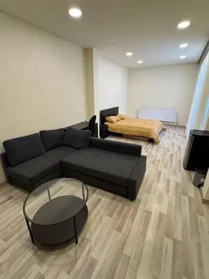 a living room with a couch and a table at مزرعة وشالية هوى الوادي