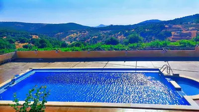 a swimming pool with a view of a mountain at Mountain Oak Chalet شالية ملول الجبل in Al Jafr