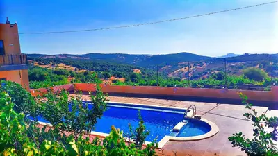 a swimming pool with a view of a mountain at Mountain Oak Chalet شالية ملول الجبل in Al Jafr