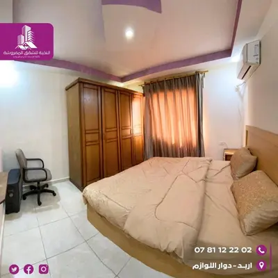 a bedroom with a bed and a chair in it at النخبة للشقق الفندقية AlNukhba suites in Irbid