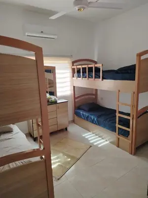 a room with two bunk beds and a desk at العقبة in Aqaba
