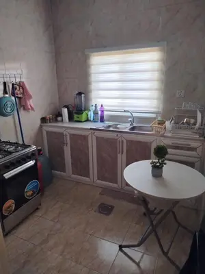 a kitchen with a sink and a table in it at العقبة in Aqaba