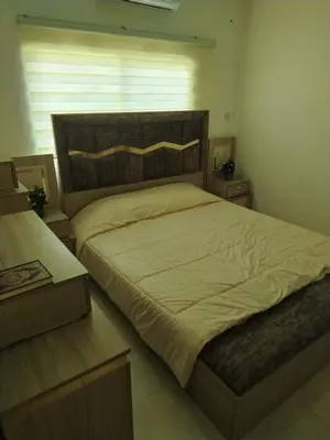 a bedroom with a large bed and a window at العقبة in Aqaba
