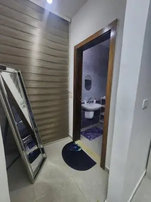 a bathroom with a sink and a toilet and a mirror at اللجين 6m in Irbid