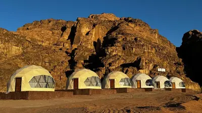 a group of domes in front of a mountain at wadi rum gem in Disah