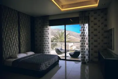 a bedroom with a bed and a large glass window at Luxurious private villa in Mahis in Māḩiş