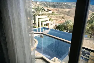 a view of a swimming pool from a window at Luxurious private villa in Mahis in Māḩiş