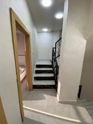 a hallway with a staircase in a house at Nabila Chalet in Sowayma