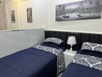 two beds sitting next to each other in a bedroom at استوديو الجاردنز gardens studio 319 in Al Jafr