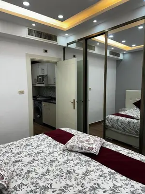 a bedroom with two beds and a kitchen in it at استوديو الرابية 19 studio alrabyeh in Al Jafr