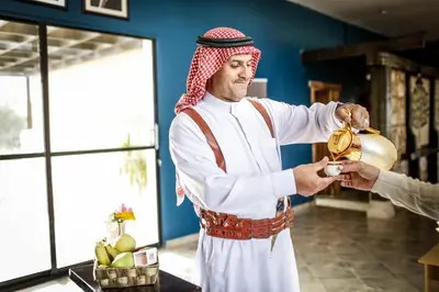 a man is pouring food into a pot at فندق مونتريال الشوبك in Al Jāyah