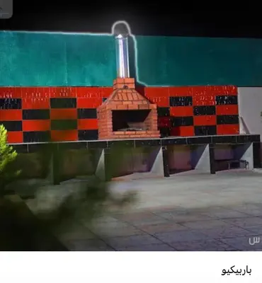 a building with a brick oven in front of it at Enjoy moment chalet