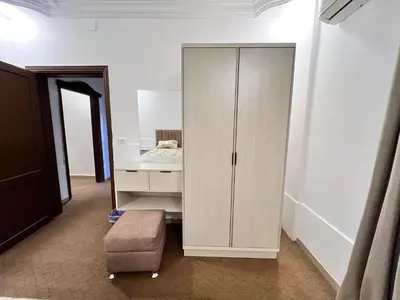 a white cabinet in a room with a mirror at الفاخر للشقق الفندقيه in Al Mafraq