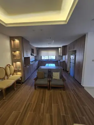 a large living room with a bed and a couch at Le Jardin in Madaba