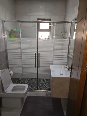 a bathroom with a shower and a toilet and a sink at Le Jardin in Madaba