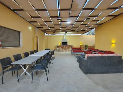 a conference room with tables and chairs and a stage at Janna2Villa in Tall al Misţāḩ