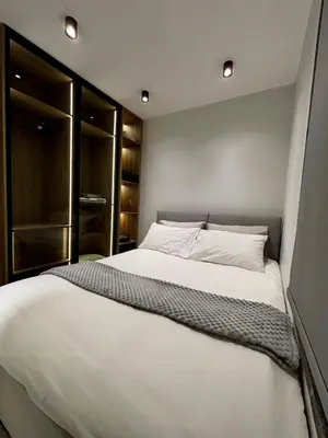 a bedroom with a large white bed with lights on it at Luxury Roof-top in Amman