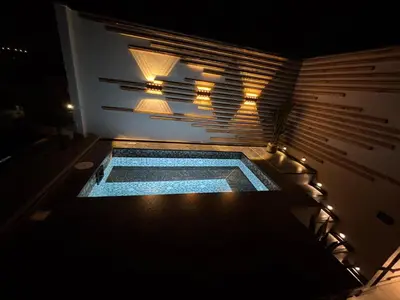 a small swimming pool with lights in a room at Luxury Roof-top in Amman