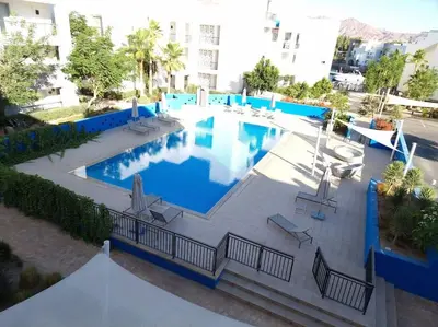 an overhead view of a swimming pool in a building at Island Apartment in Aqaba
